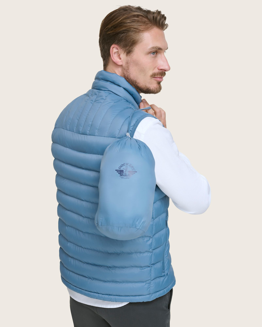 View of model wearing Blue Packable Puffer Vest.