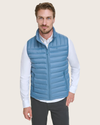 View of model wearing Blue Packable Puffer Vest.