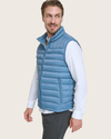 Side view of model wearing Blue Packable Puffer Vest.