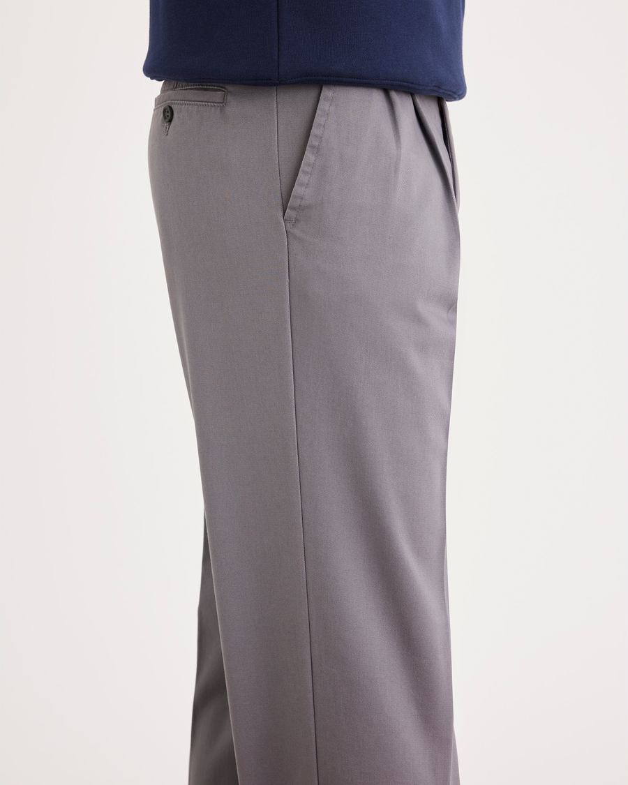 Side view of model wearing Burma Grey Easy Khakis, Pleated, Classic Fit.