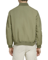 Back view of model wearing Camo Olive Recycled Sail Nylon Bomber Jacket.