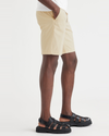 Side view of model wearing Caravan Lucent White Ultimate 9.5" Shorts.