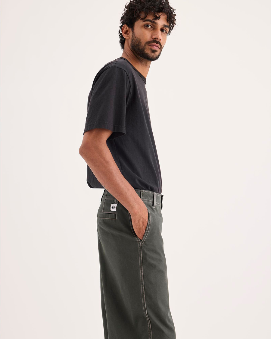 Side view of model wearing Chimera Eighty-Six Alpha Chino Pants, Loose Fit.