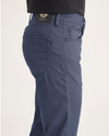 Side view of model wearing Crown Blue Jean Cut Pants, Slim Fit.