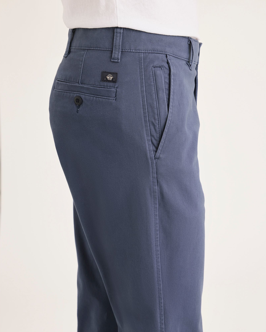 Side view of model wearing Crown Blue Ultimate Chinos, Slim Fit.