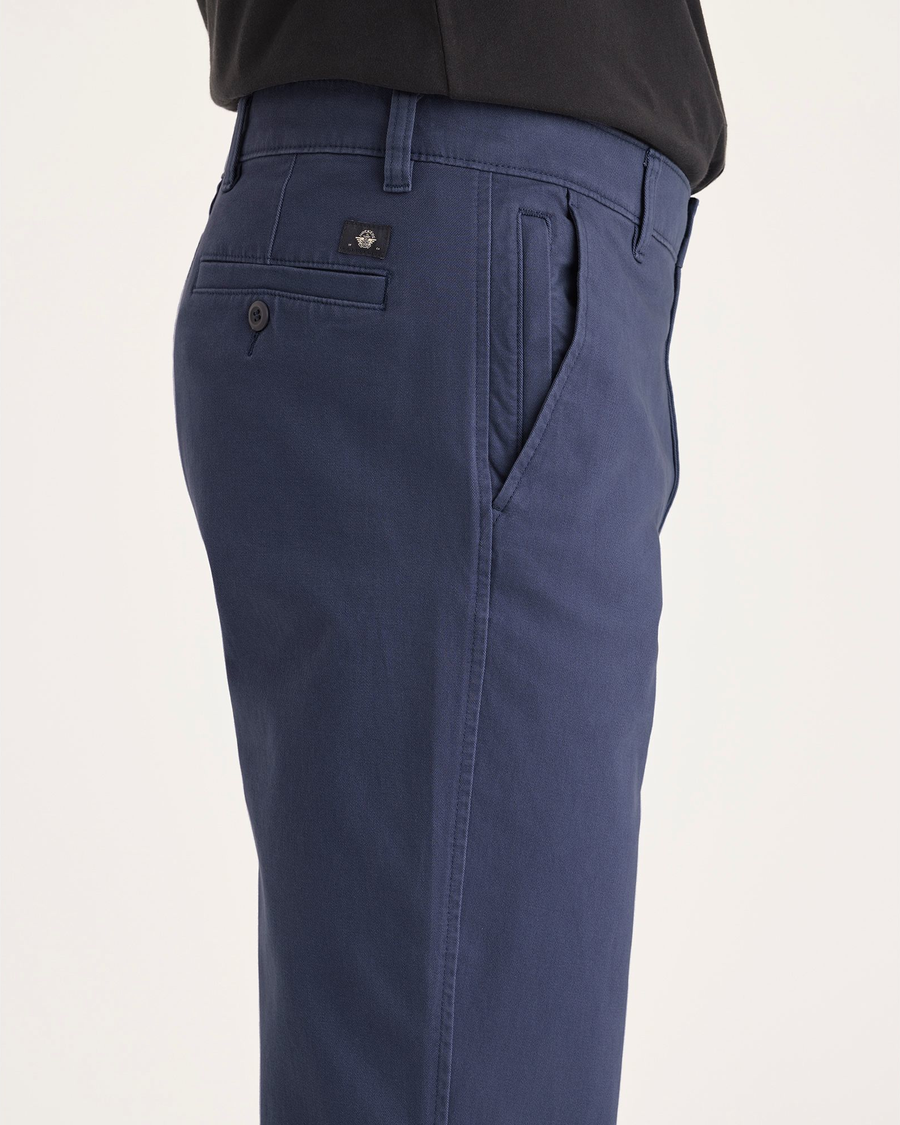 Side view of model wearing Crown Blue Ultimate Chinos, Straight Fit.