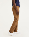 Side view of model wearing Dark Ginger Ultimate Chinos, Athletic Fit.