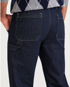 View of model wearing Dark Indigo Rinse California Carpenter Pants, Straight Fit.