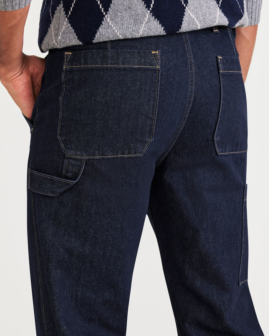 View of model wearing Dark Indigo Rinse California Carpenter Pants, Straight Fit.