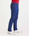 Side view of model wearing Dark Indigo Stonewash Jean Cut Pants, Slim Fit.