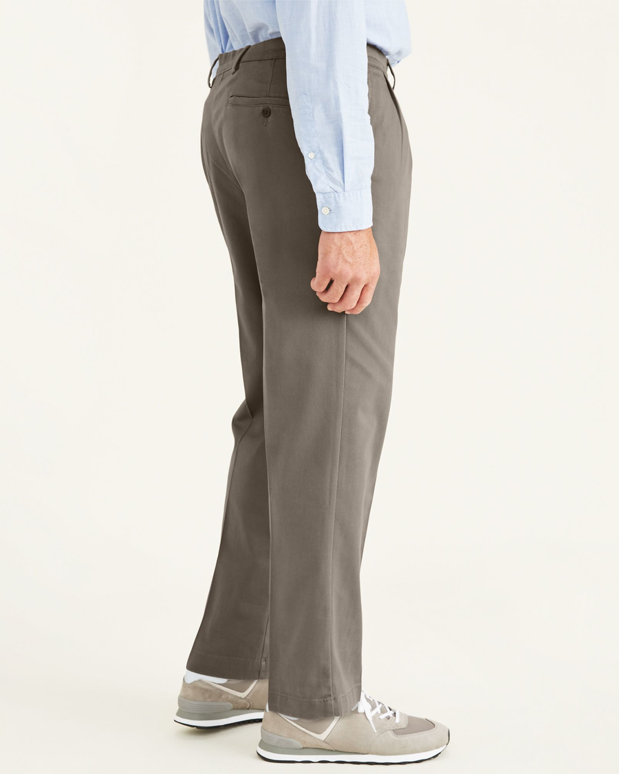 Side view of model wearing Dark Pebble Easy Khakis, Pleated, Classic Fit (Big and Tall).