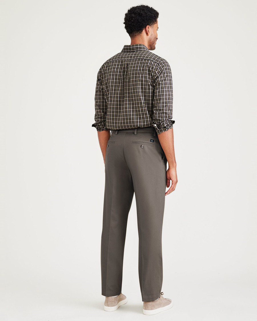 Back view of model wearing Dark Pebble Signature Iron Free Khakis, Pleated, Classic Fit with Stain Defender®.