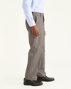 Side view of model wearing Dark Pebble Signature Khakis, Classic Fit.