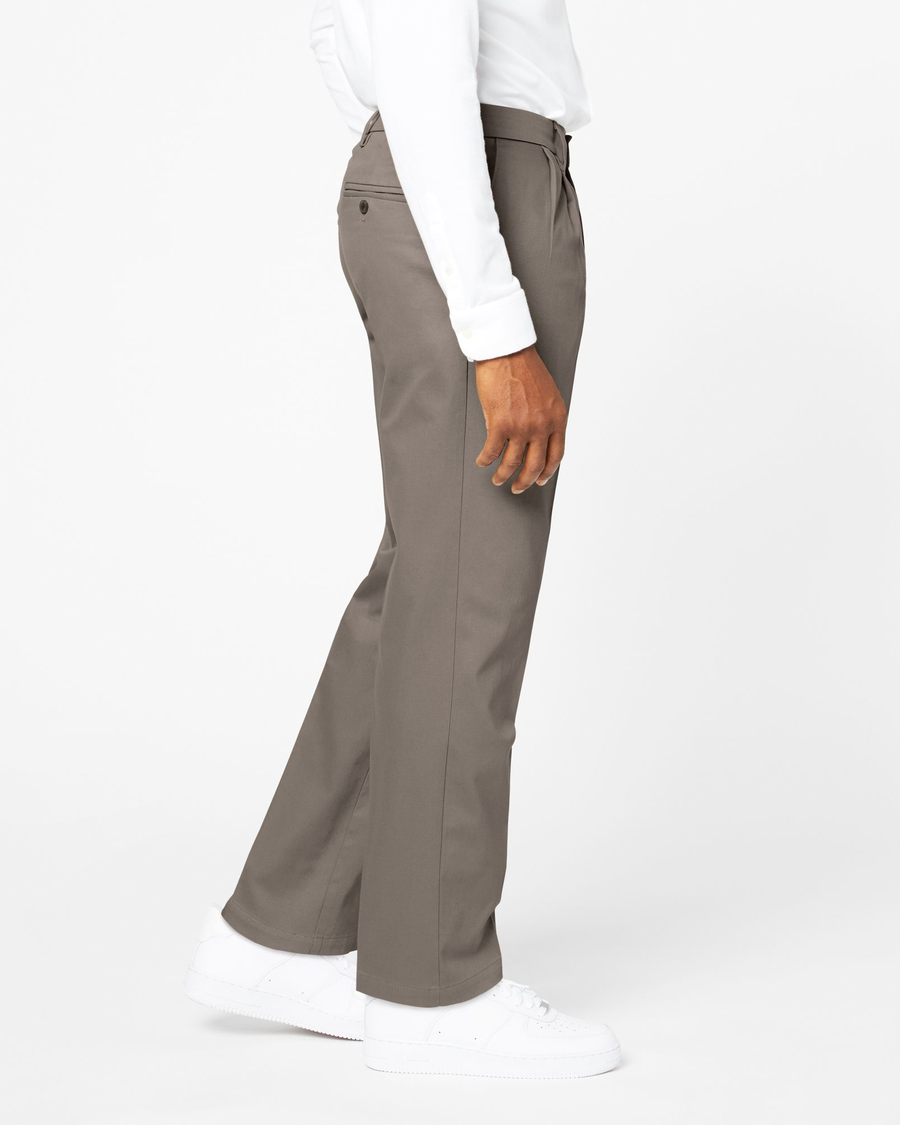 Side view of model wearing Dark Pebble Signature Khakis, Pleated, Classic Fit.