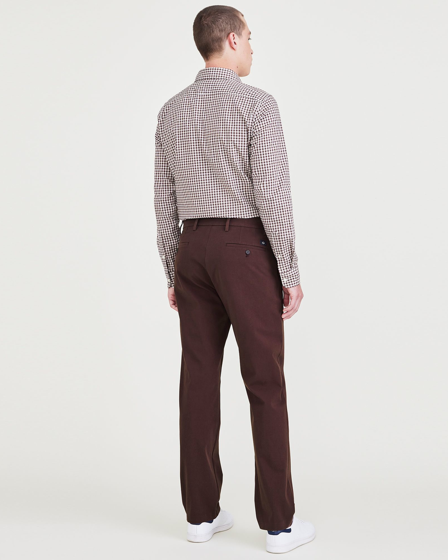 Back view of model wearing Decadent Chocolate City Tech Trousers, Slim Fit.