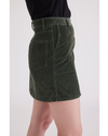 Side view of model wearing Deep Forest Button Front Mini Skirt.