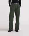 Front view of model wearing Deep Forest Pleated Pants, High Wide Fit.