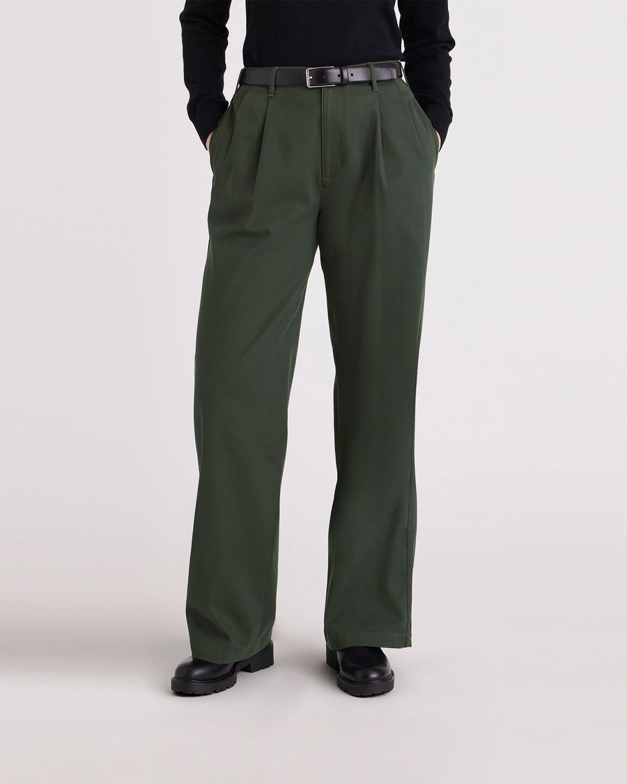 Front view of model wearing Deep Forest Pleated Pants, High Wide Fit.