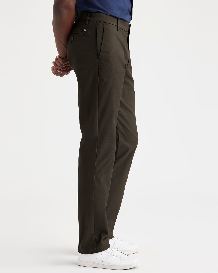 Side view of model wearing Fern City Tech Trousers, Slim Fit.