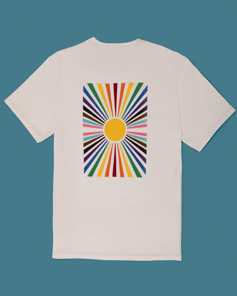 View of model wearing Full Sunburst Rainbow Pride Tee.