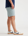 Side view of model wearing Harbor Grey Ultimate 9.5" Shorts, Straight Fit.