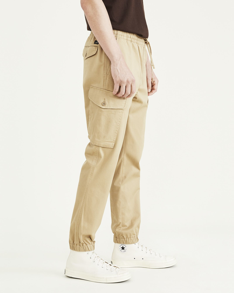 Side view of model wearing Harvest Gold Cargo Joggers, Straight Tapered Fit.