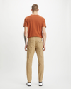 Back view of model wearing Harvest Gold Cargo Pants, Slim Tapered Fit.