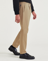 Side view of model wearing Harvest Gold Crafted Trousers, Slim Tapered Fit.