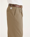 Side view of model wearing Harvest Gold Eighty-Six Original Pleated Chinos, Loose Fit.