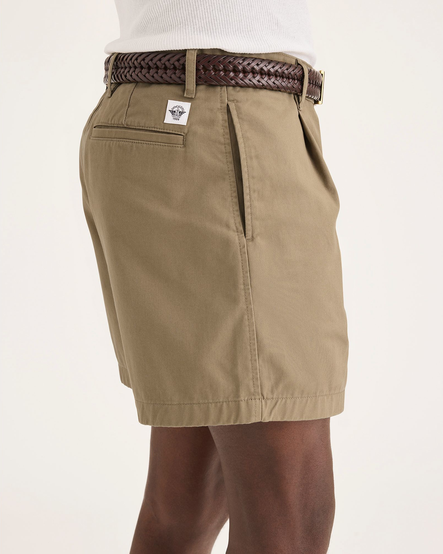 Side view of model wearing Harvest Gold Eighty-Six Pleated Short.