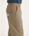 Side view of model wearing Harvest Gold Eighty-Six Utility Pants, Loose Fit.