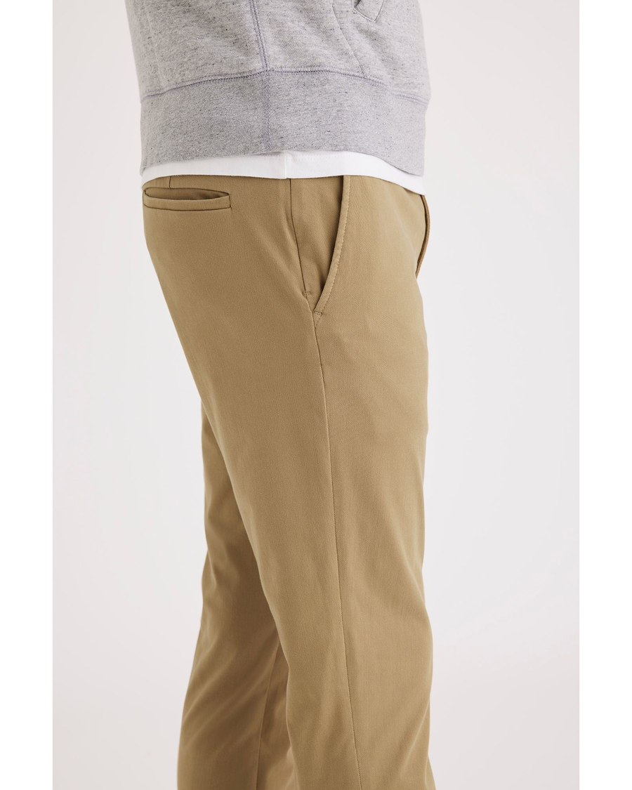 Side view of model wearing Harvest Gold Go Lifestyle Chino, Skinny Fit.