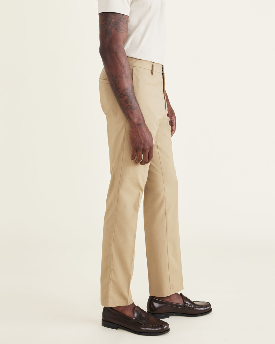 Side view of model wearing Harvest Gold Signature Go Khakis, Slim Fit.