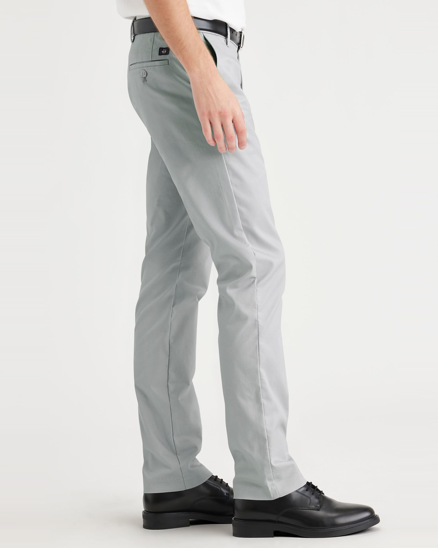 Side view of model wearing High Rise City Tech Trousers, Slim Fit.