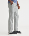 Side view of model wearing High Rise City Tech Trousers, Straight Fit.