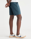 Side view of model wearing Indian Teal Ultimate 9.5" Shorts, Straight Fit.