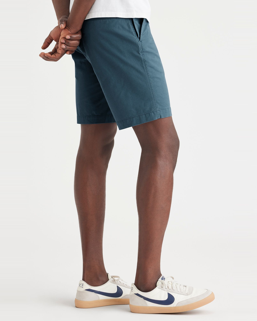 Side view of model wearing Indian Teal Ultimate 9.5" Shorts, Straight Fit.