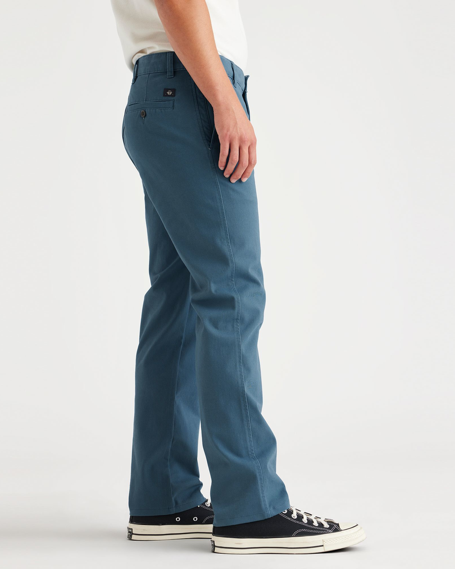 Side view of model wearing Indian Teal Ultimate Chinos, Slim Fit.