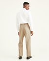 View of model wearing Khaki Easy Khakis, Pleated, Relaxed Fit.