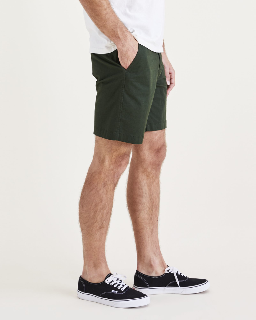 Side view of model wearing Lemon Curry Ultimate 9.5" Shorts (Big and Tall).