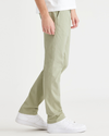 Side view of model wearing Lint Ultimate Chinos, Slim Fit.