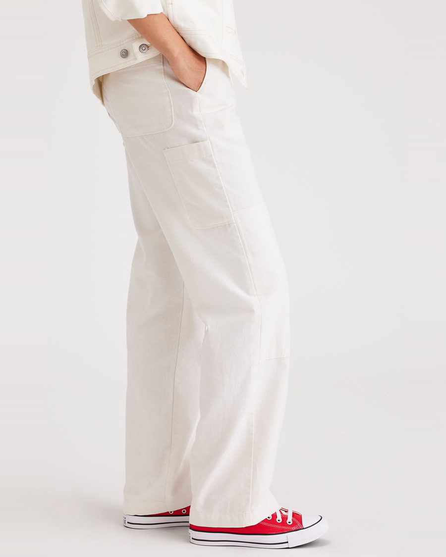 Side view of model wearing Lucent White Carpenter Pant, Straight Fit.