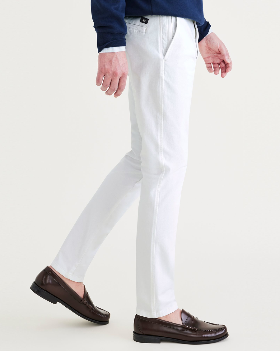 Side view of model wearing Lucent White Ultimate Chinos, Skinny Fit.