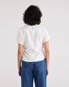 Back view of model wearing Lucent White Wrap Blouse, Regular Fit.