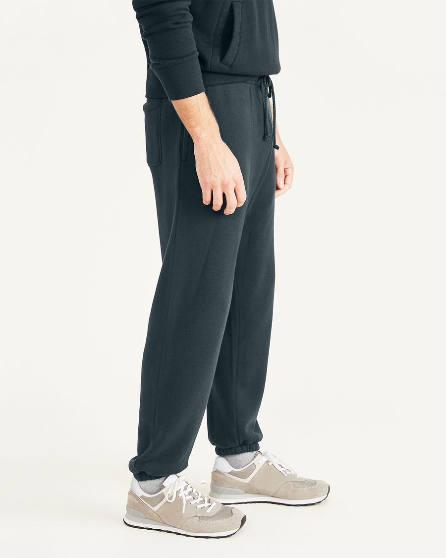 Side view of model wearing Magical Forest Sport Sweatpants, Straight Fit.