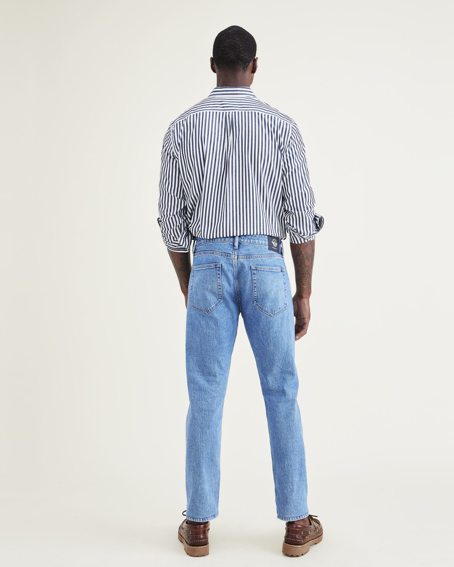 Back view of model wearing Medium Indigo Stonewash Jean Cut Pants, Slim Fit.