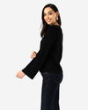 Side view of model wearing Mineral Black Bell Sleeve Sweater.