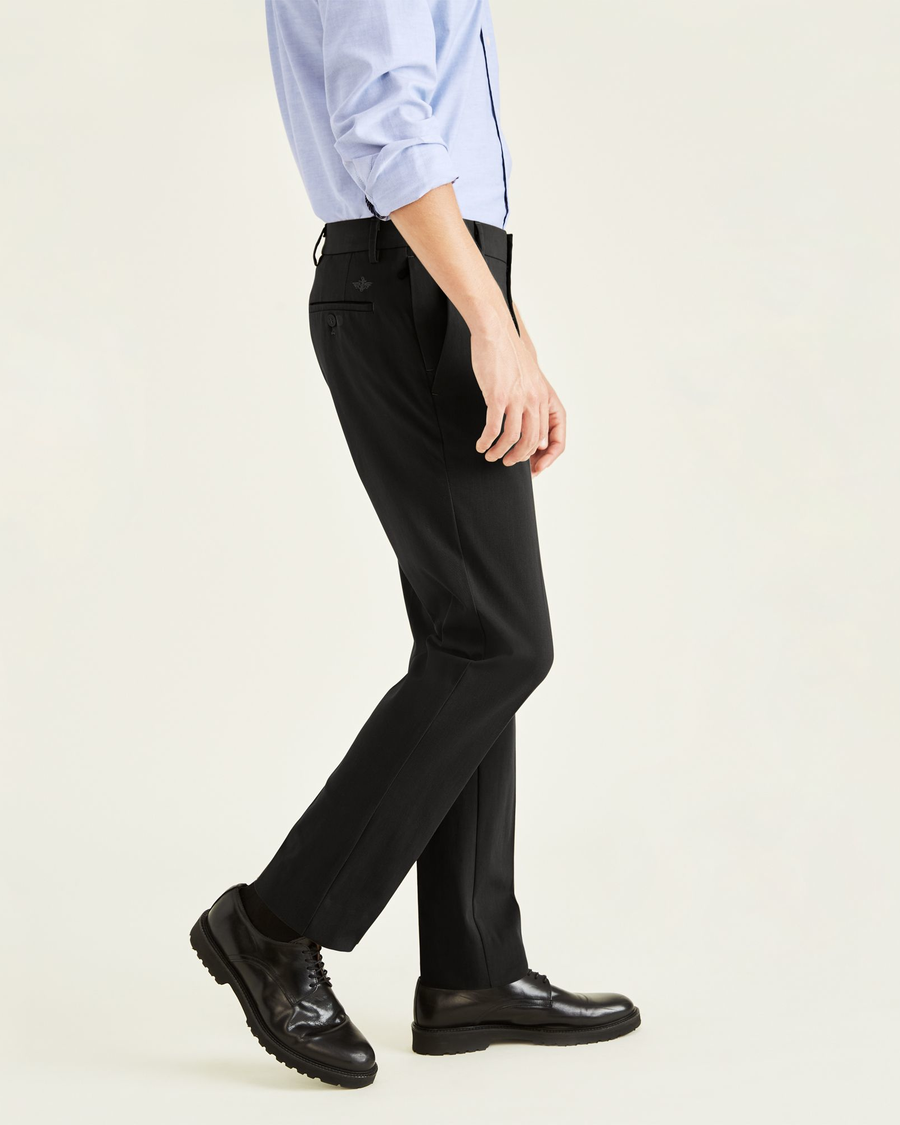Side view of model wearing Mineral Black City Tech Trousers, Slim Fit.