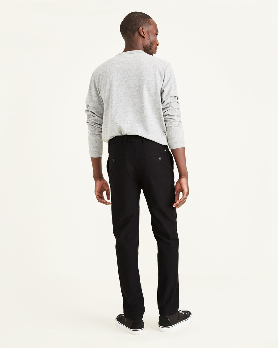 Back view of model wearing Mineral Black Comfort Knit Chinos, Slim Fit.