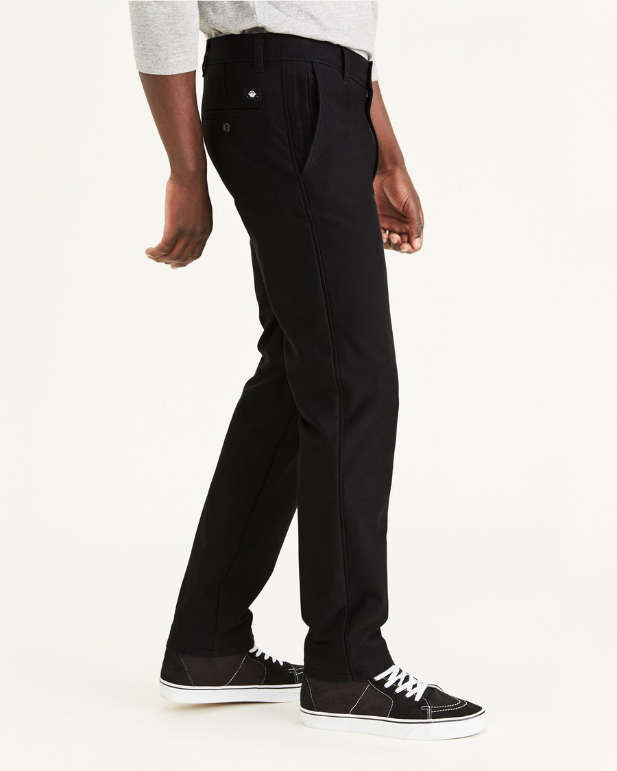 Side view of model wearing Mineral Black Comfort Knit Chinos, Slim Fit.